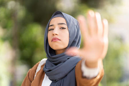Serious muslim woman gesturing stop with the handの写真素材