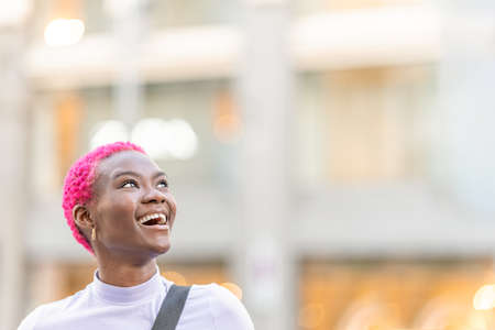 Beauty african woman looking up to the sky while smilingの写真素材