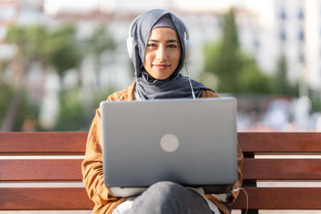 Portrait of a muslim woman using a laptopの写真素材