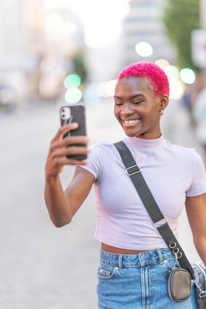 African woman with pink hair taking a selfie