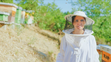 Portrait of a female beekeeper in a fieldの写真素材