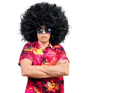 Offended man in Afro wig crossing armsの写真素材