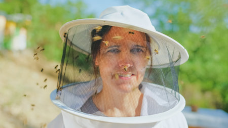 Bees flying around the face of a beekeeperの写真素材