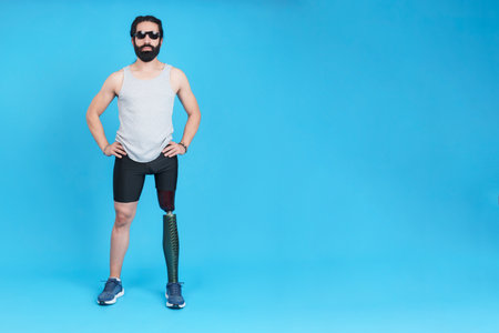 Bearded man with sunglasses and a prosthetic legの写真素材