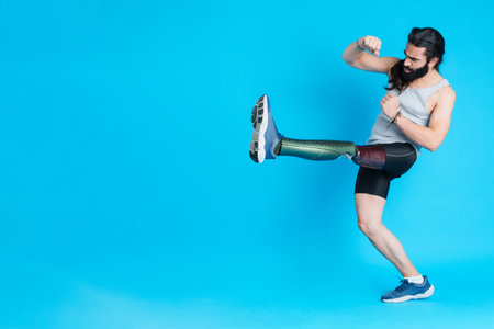 Man with a prosthesis on his leg kicking and fightingの写真素材