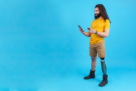 Studio portrait of a man with prosthesis on his legの写真素材