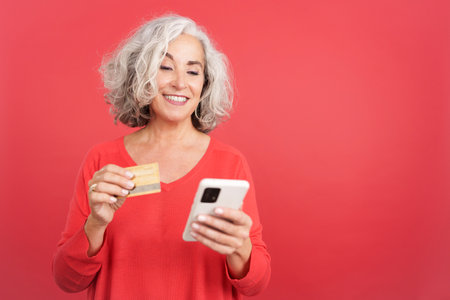 Woman using a card to shopping online with the mobileの写真素材