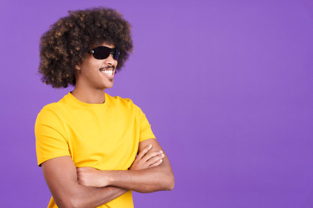 Smiley african man wearing sunglasses posing with arms crossedの写真素材