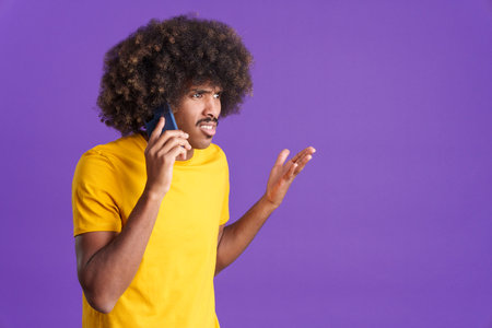 Angry african man talking to the mobile
