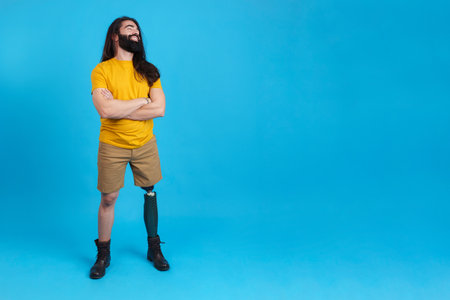 Smiling man with prosthetic leg looking to the copy space asideの写真素材