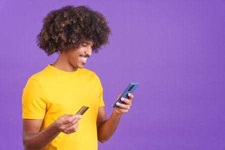 African man using the mobile and card to shopping online