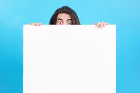 Man holding a board with blank spaceの写真素材