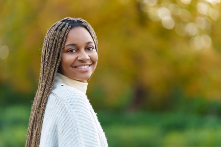 African woman turning to smile at the camera