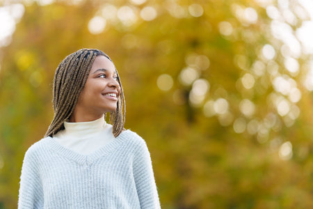 Distracted african woman looking up in a park