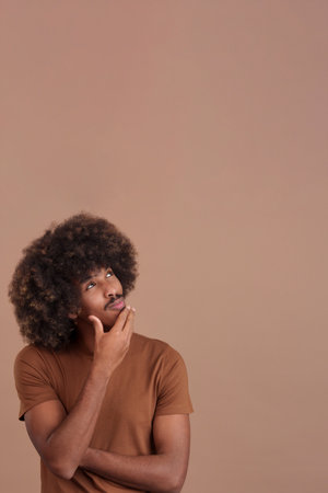African man with hand on face and thoughtful expressionの写真素材