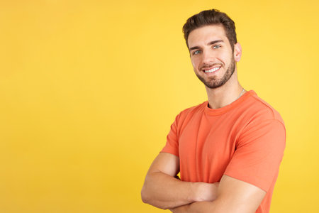 Handsome man standing whit arms crossed smiling at the cameraの写真素材