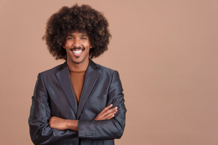 Smiley stylish african man with a jacket looking at cameraの写真素材
