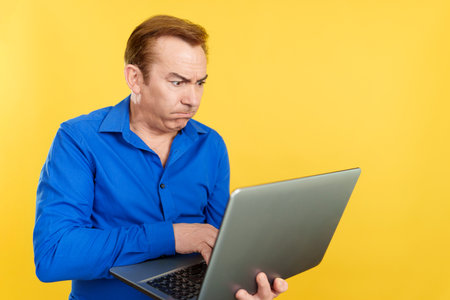 Mature man with a problem with a laptop