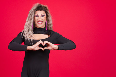 Drag queen man representing a heart in the shape of fingersの写真素材