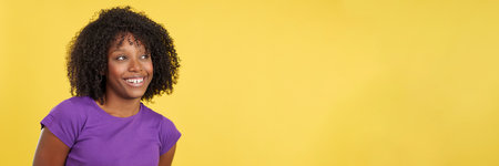 Cool woman with afro hair looking to a blank spaceの写真素材
