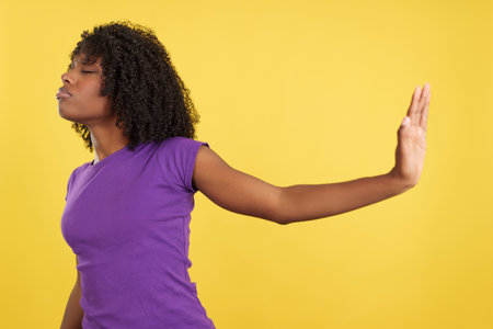 Woman with afro hair refusing something with the handの写真素材