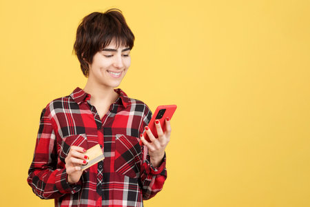 Androgynous person shopping online with a mobileの写真素材