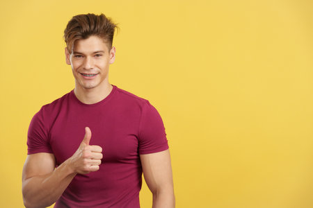 Strong man gesturing approval with the thumb upの写真素材