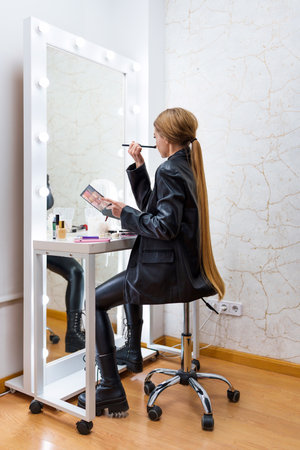 Rear view of a woman making up on a backstageの写真素材