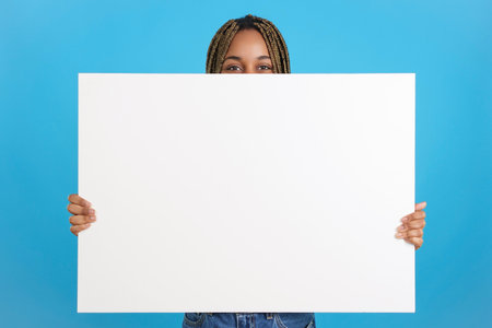 African woman holding a poster in whiteの写真素材