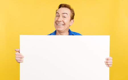 Smiley mature man holding a blank panelの写真素材