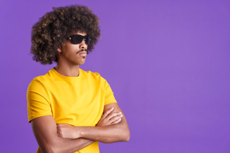 Serious african man wearing sunglasses posing with arms crossedの写真素材