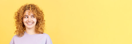 Happy woman with curly hair looking asideの写真素材