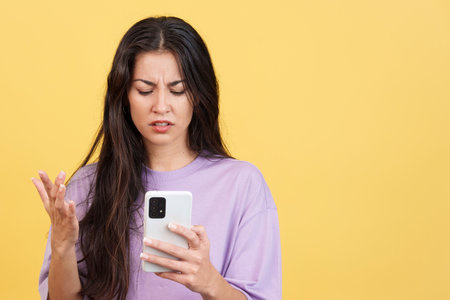Worried caucasian woman using a mobile phoneの写真素材