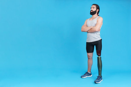 Man standing with a leg prosthesis with his arms crossedの写真素材