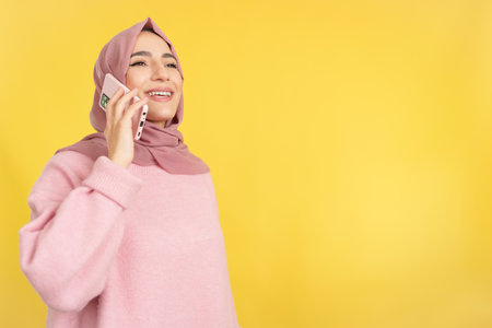 Happy muslim woman talking to the mobileの写真素材