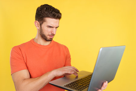 Caucasian man having a problem with a laptopの写真素材