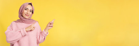 Muslim woman indicating a blank space to the sideの写真素材