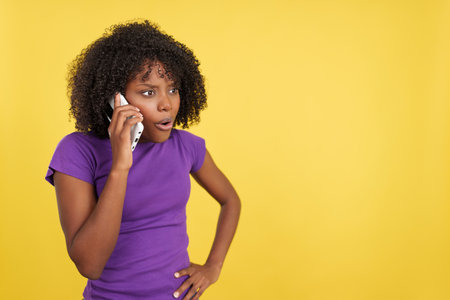 Afro woman talking to the mobile with angry expressionの写真素材