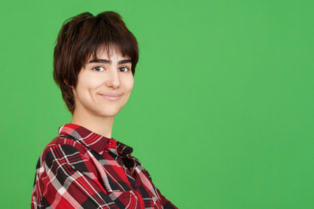 Androgynous person looking at the camera and smilingの写真素材