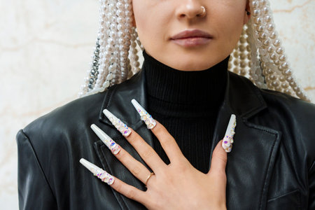 Woman showing long and decorated fake nailsの写真素材