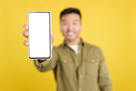 Blank screen of the mobile held by a chinese manの写真素材