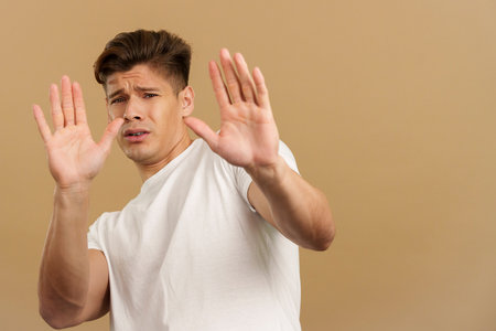 Handsome man gesturing with the hands in fearの写真素材