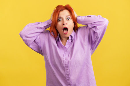 Surprised mature woman gesturing and looking at the cameraの写真素材