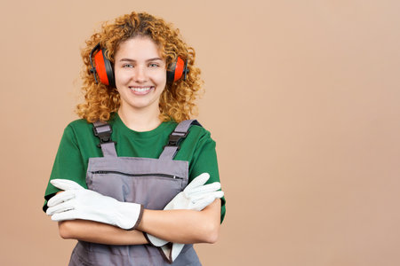 Smiley woman carpentry worker with tools and work uniformの写真素材