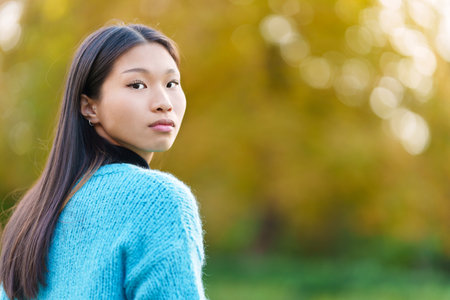 Asian woman turning to look at the cameraの写真素材