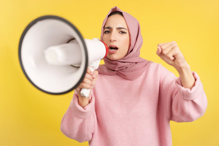 Angry muslim woman screaming using a loudspeakerの写真素材