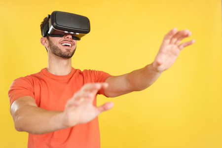 Caucasian man gesturing while wearing Virtual Reality gogglesの写真素材