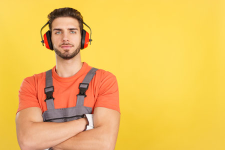 Serious worker standing with arms crossed looking at cameraの写真素材