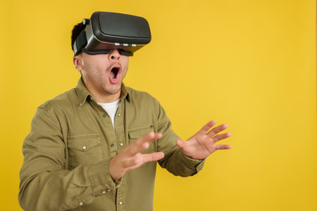 Surprised chinese man with Virtual Reality gogglesの写真素材