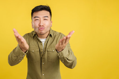Chinese man blowing a kiss while looking at the cameraの写真素材